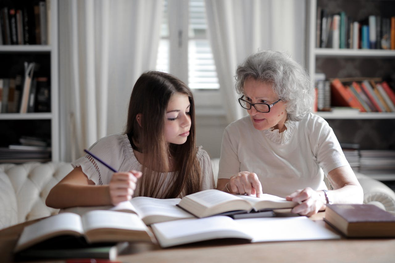 an elder teaching to a teenager