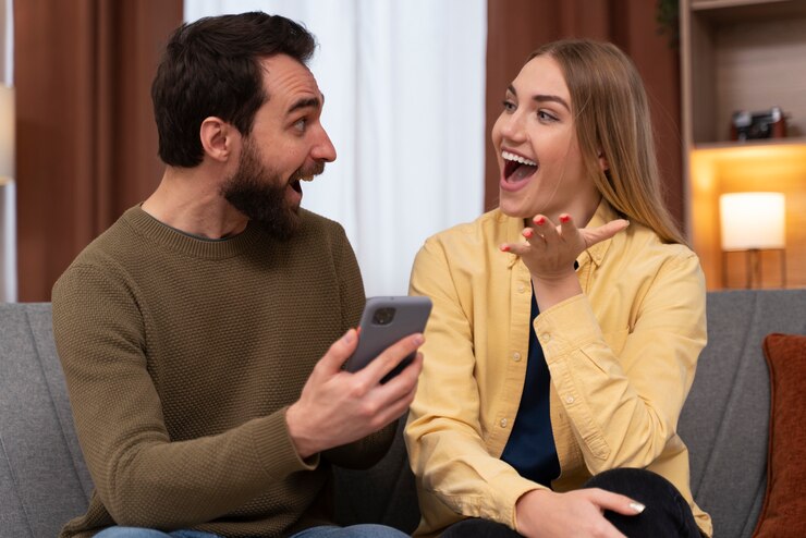 Man and woman chatting with a big smile on their faces